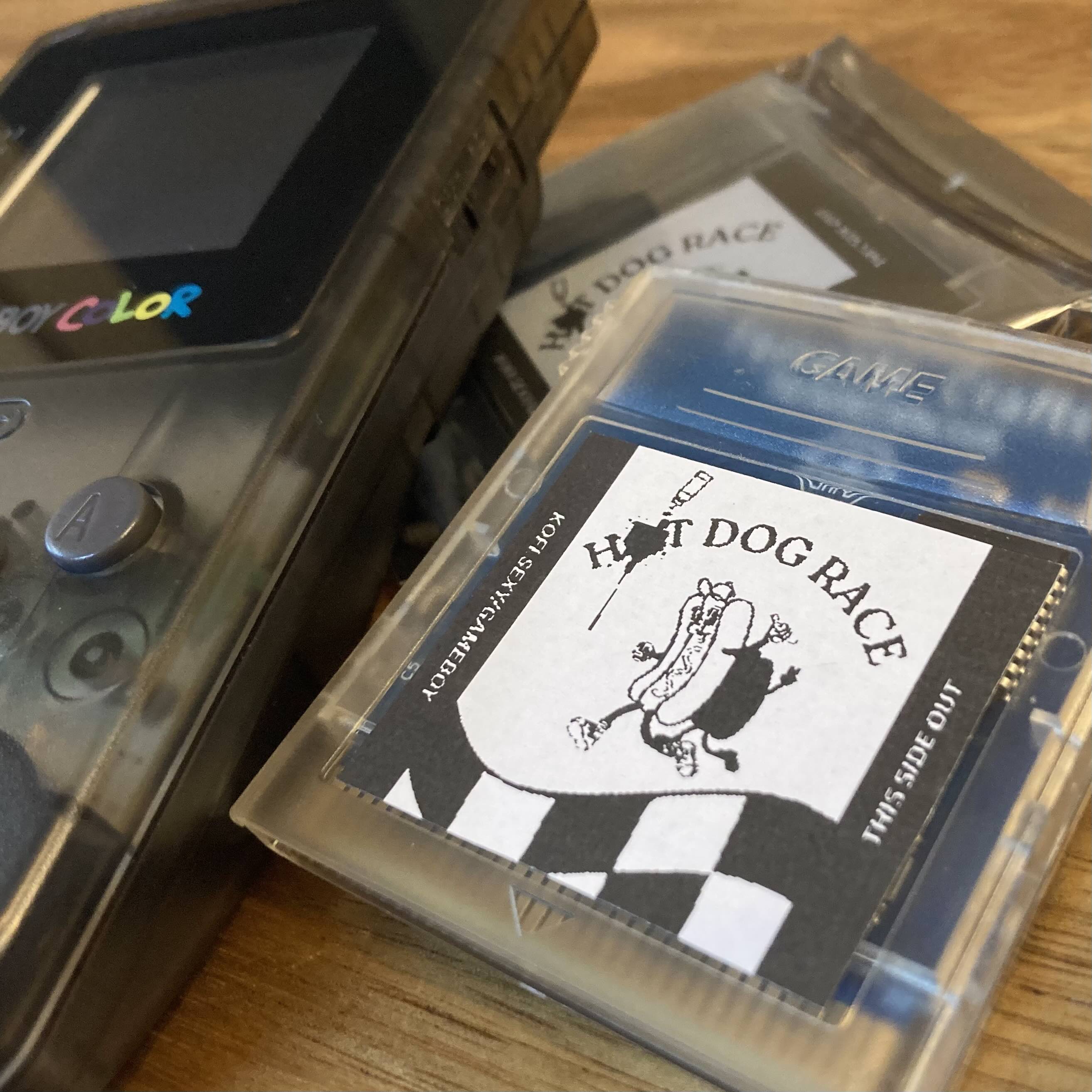 Hot Dog Race cartridge beside a Game Boy color